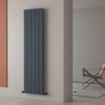 Modern vertical grey radiator in stylish home interior.