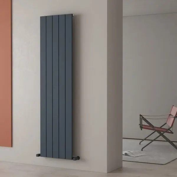 Modern vertical grey radiator in stylish home interior.