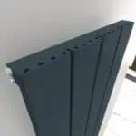 Modern black radiator, sleek and slim design, ideal for home heating solutions.