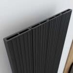 Black aluminum radiator with vertical fins for optimal heat dissipation.