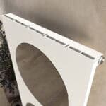 White radiator with mounting brackets for home heating.