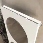 White radiator with mounting brackets for home heating.