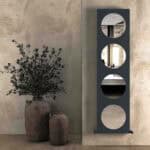 Vintage ceramic vases with olive branches in a modern interior setting.