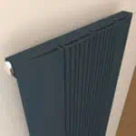 Modern navy blue radiator with sleek vertical design for contemporary home heating.