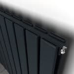 Radiator heating system, modern black panel radiator in close-up, home heating solution, energy-efficient heating technology, comfortable indoor climate.