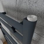Modern black and silver retractable coat hook for retail and shop displays.