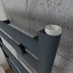 Modern black and silver retractable coat hook for retail and shop displays.