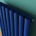 Radiator close-up with blue panels and modern design for home heating.