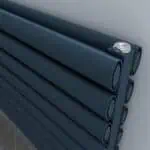 Flexible black piping rolls for plumbing or irrigation systems, close-up image.
