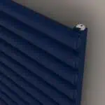 Blue pipe rack with screws, industrial storage solution for plumbing or electrical systems, metal piping organization, home or workshop use.