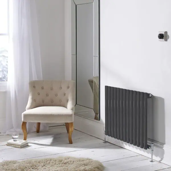 Mirror with modern design reflecting a cozy interior corner.