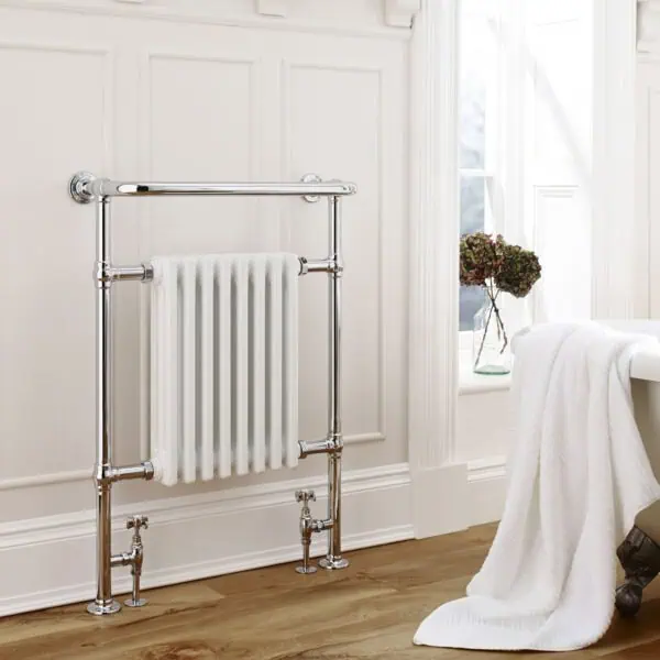 Polished chrome towel radiator in cozy bathroom setting.