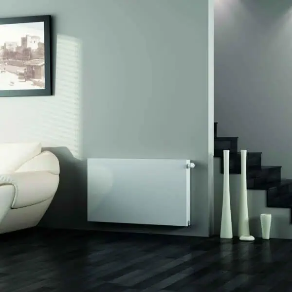 Modern living room with white sofa and minimalist decor, dark hardwood floor, and stairs, stylish interior design.