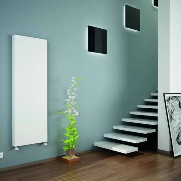 Modern home interior featuring stylish radiators, wall decor, and a staircase with artwork.
