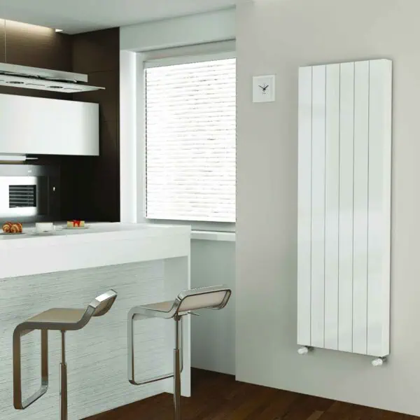 Contemporary white radiator in modern kitchen with bar stools and wooden flooring.