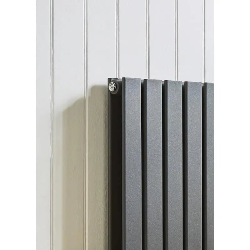 kartell-boston-anthracite-vertical-double-panel-radiator-1800mm-x-480mm Modern black radiator mounted on white panelled wall for home heating.