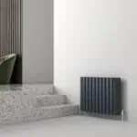 Contemporary black vertical radiator in modern interior design.