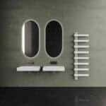 Minimalist bathroom with sleek mirrors and modern sinks for contemporary interior design.