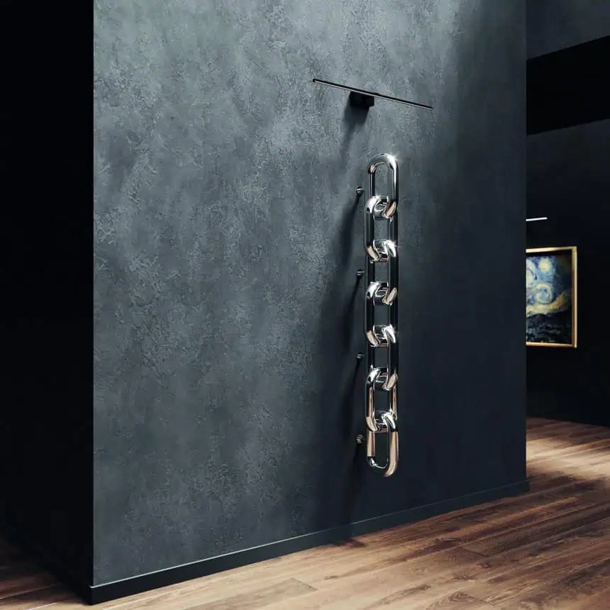 Metal chain sculpture on textured wall.