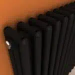 Black towel radiator wall-mounted for modern bathroom heating, sleek design, durable finish.