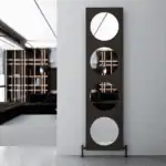 Modern decorative mirror with four circular cutouts, black frame, and minimalist design.