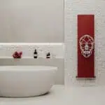 Stylish modern bathroom with decorative skull radiator and minimalist design.