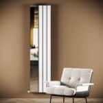 Mirror with modern frame in stylish living room setting.