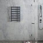 Minimalist modern bathroom with black towel rack and walk-in shower. Marble wall design creates an elegant look.